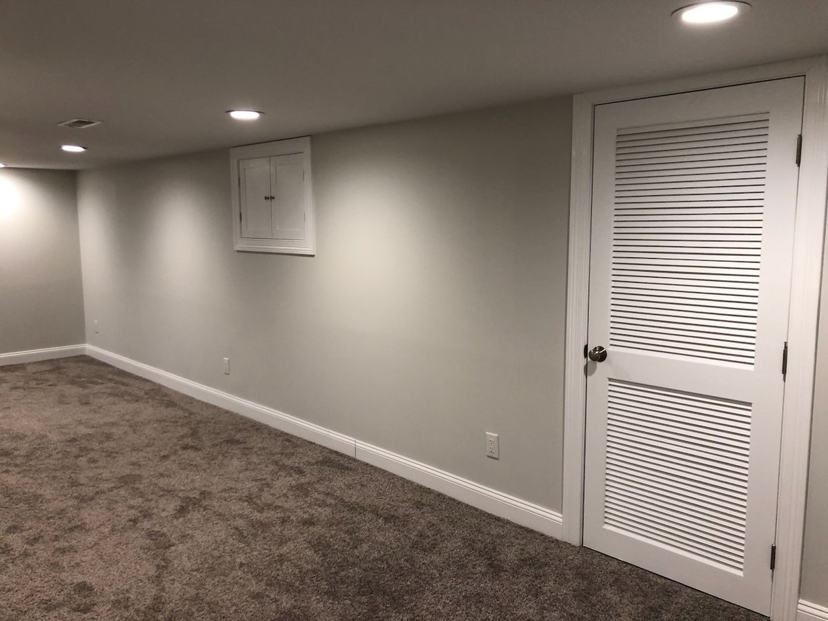 Basement closet with vented louvered door in Ridgewood, NJ custom home by Fairmount Heights Homes.