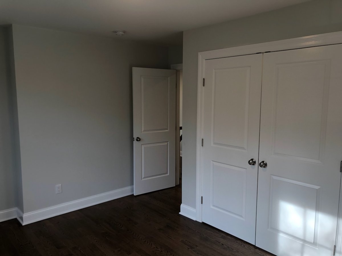 Bedroom closet with double doors in Ridgewood custom home by Fairmount Heights Homes.