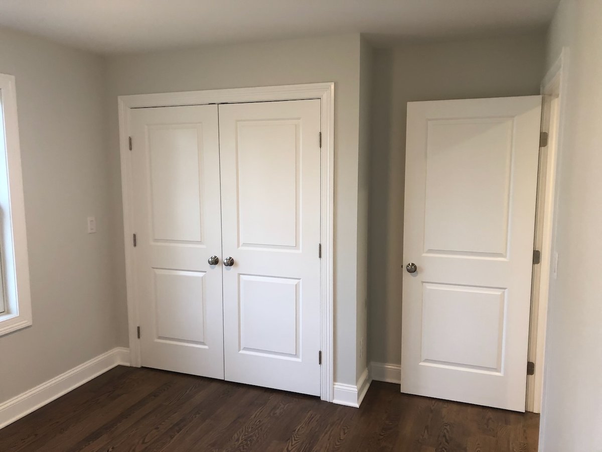 Bedroom with double closet doors in Ridgewood, NJ custom home by Fairmount Heights Homes.