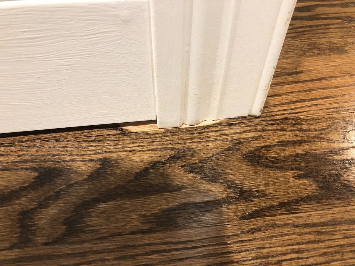 Close-up of baseboard and hardwood floor transition in Ridgewood, NJ custom home.