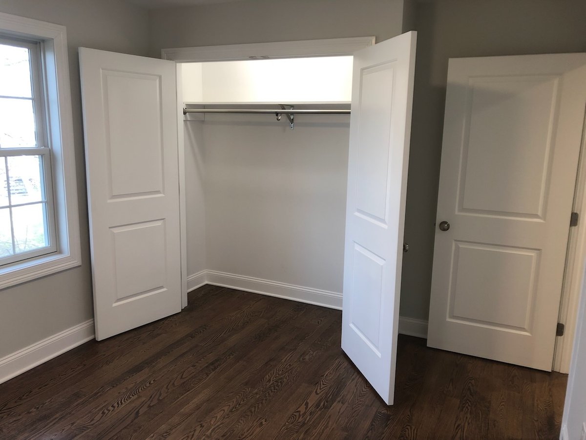 Custom bedroom closet with double doors in a Fairmount Heights Homes project in Ridgewood, NJ.