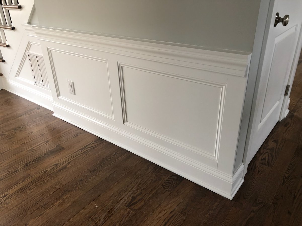 Decorative wall paneling and trim detail in Ridgewood home by Fairmount Heights Homes.