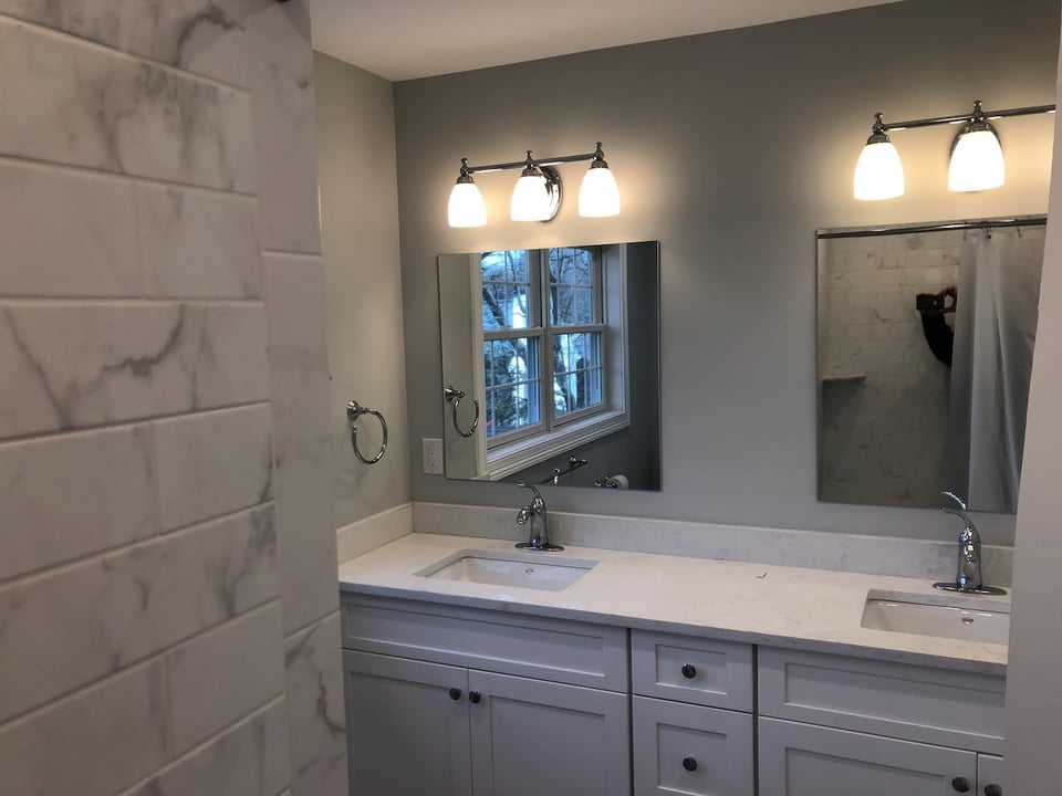 Double vanity with framed mirrors in a Ridgewood bathroom remodel by Fairmount Heights Homes