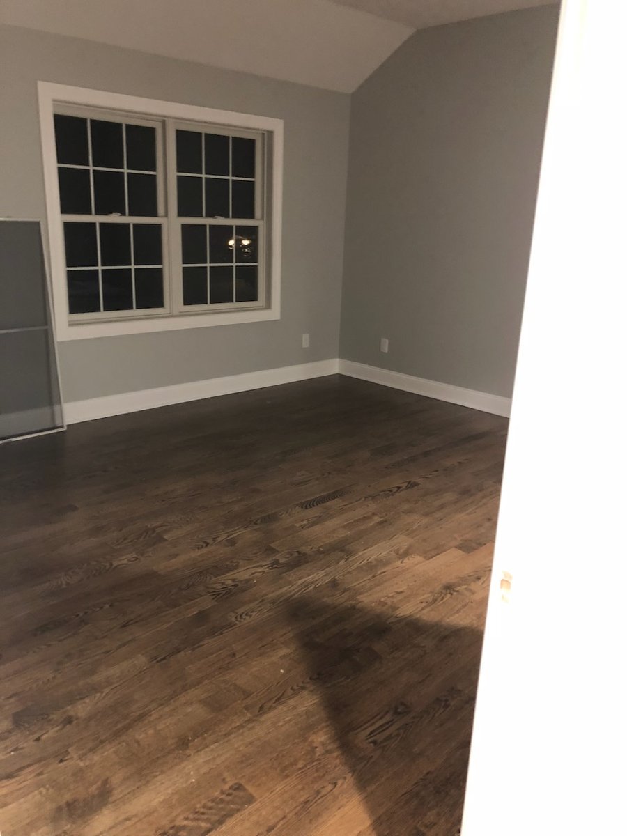 Empty bedroom with vaulted ceiling and large window in Ridgewood, NJ custom home.
