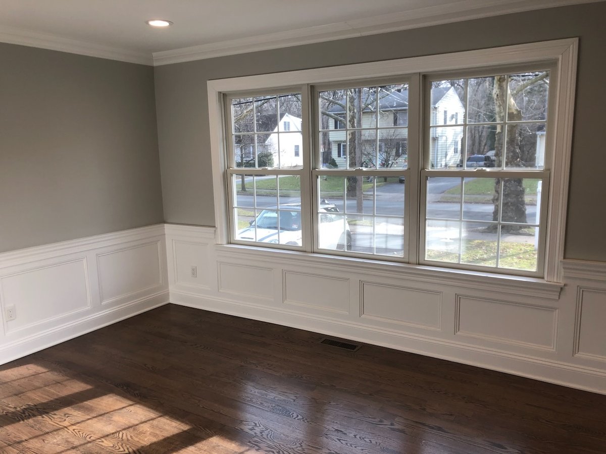 Formal sitting area with elegant trim work and natural light by Fairmount Heights Homes.