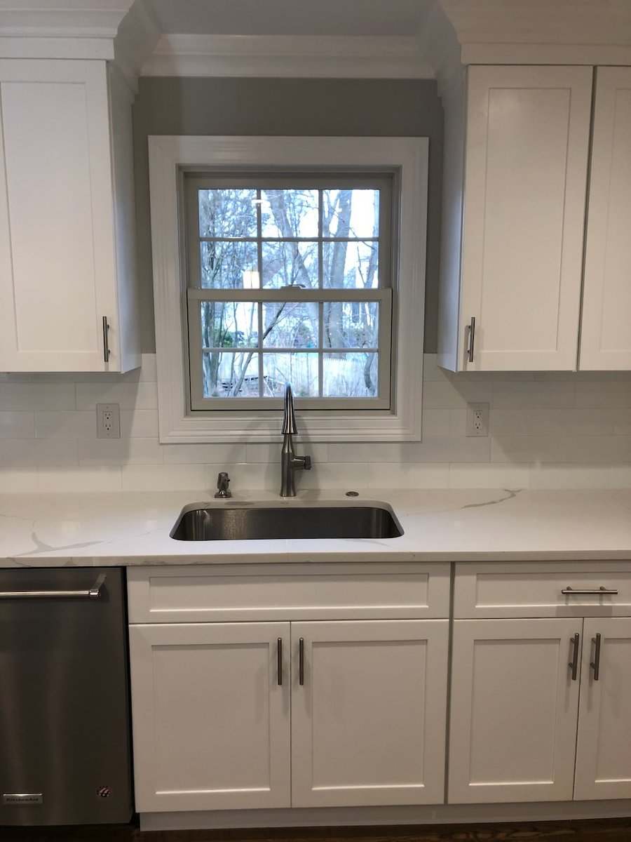 Kitchen sink area with white shaker cabinets in Ridgewood, NJ home by Fairmount Heights Homes.