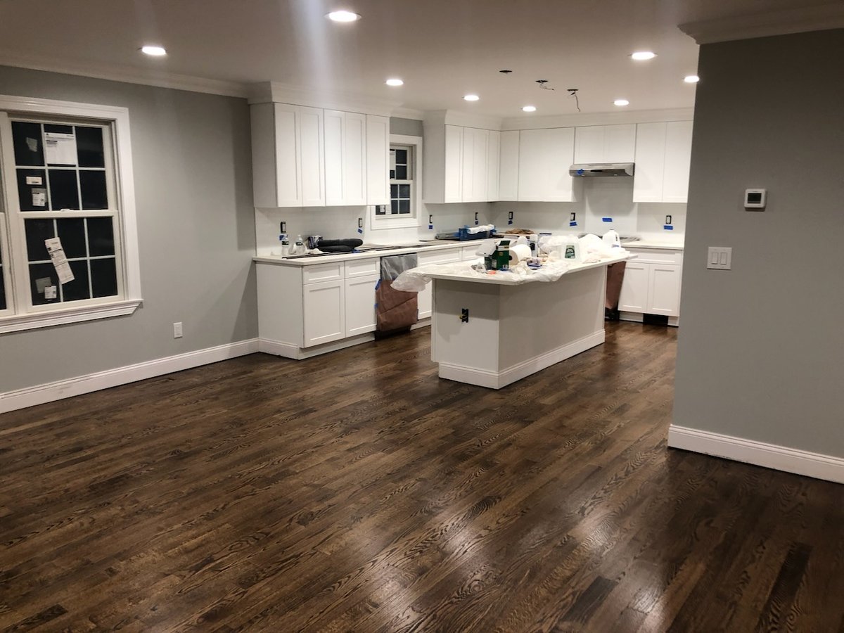 Kitchen under construction with white cabinets and hardwood flooring in Ridgewood, NJ custom home.