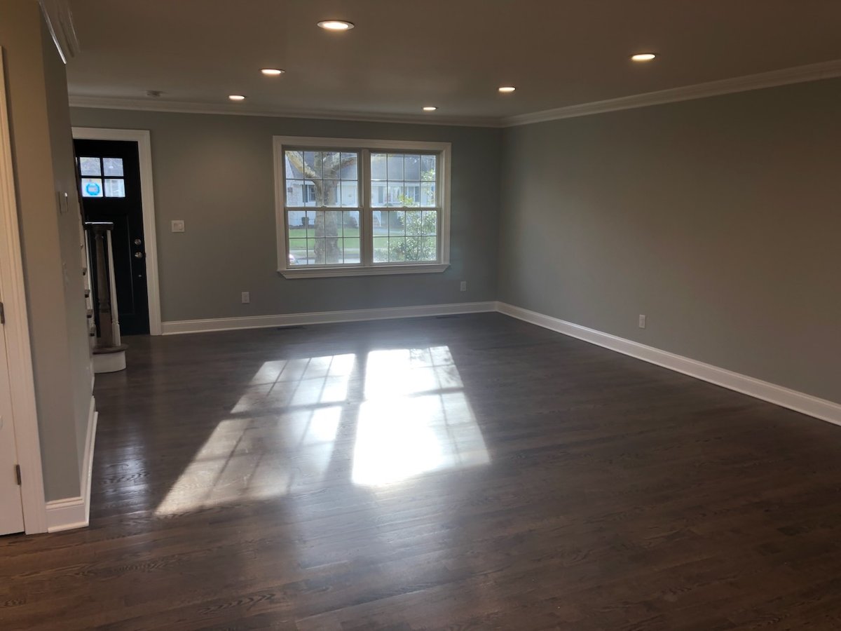 Living room with front-facing window and recessed lighting in Ridgewood, NJ custom home.