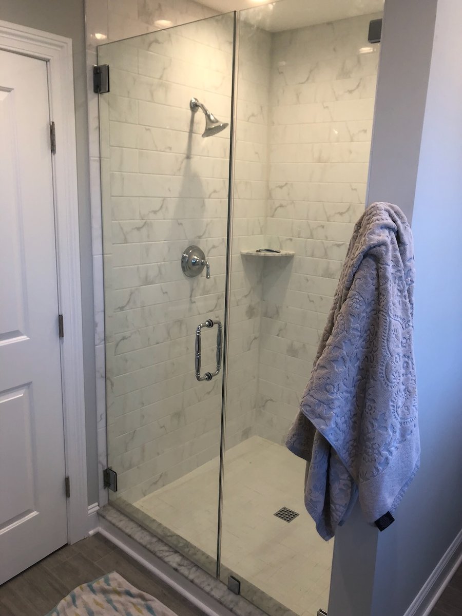 Modern bathroom remodel featuring tiled shower enclosure in Ridgewood, NJ by Fairmount Heights Homes.