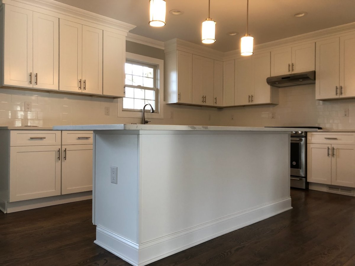 Open kitchen layout with island and pendant lighting in Ridgewood, NJ home by Fairmount Heights Homes.