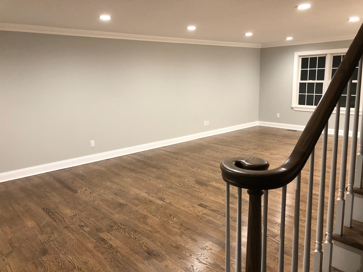 Open living space with recessed lighting and hardwood floors in Ridgewood, NJ custom home.