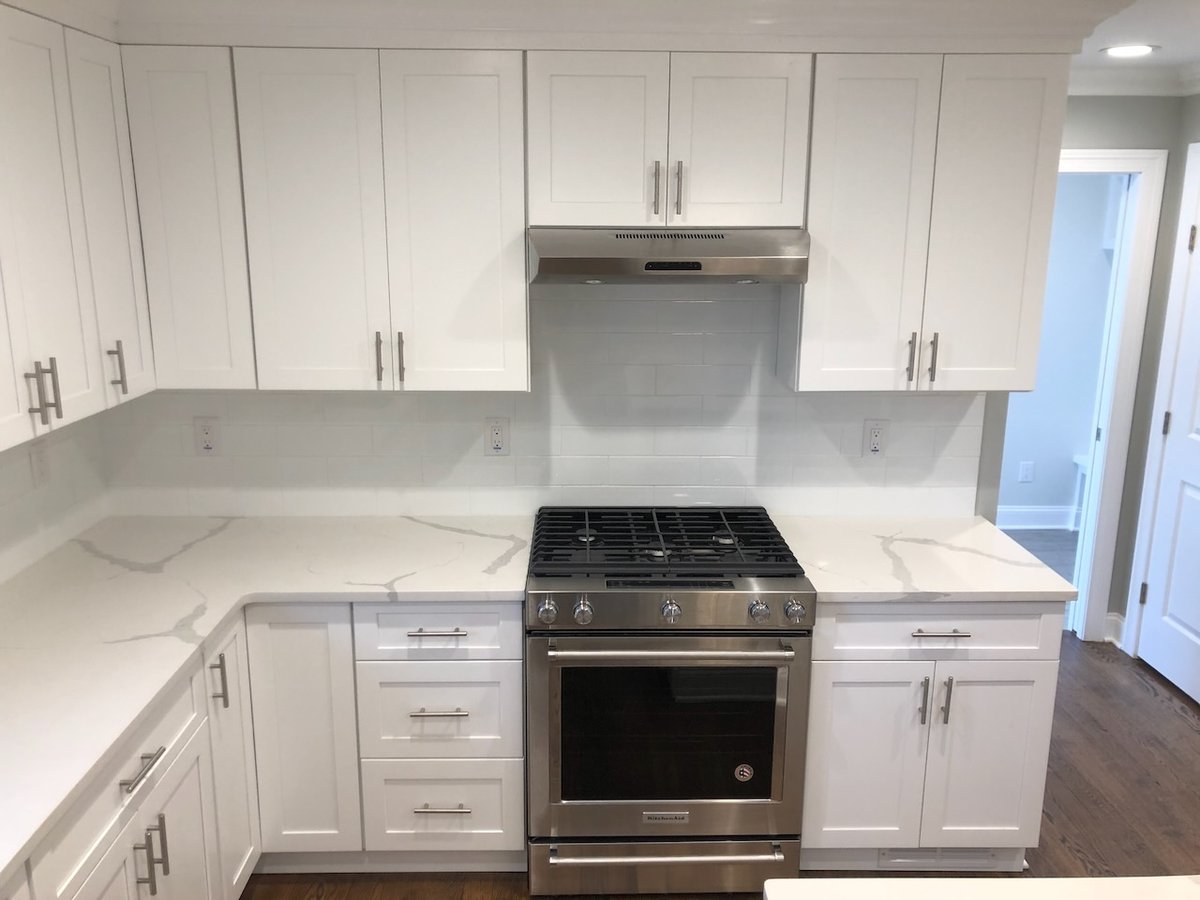Quartz counters and gas cooktop in custom Ridgewood kitchen by Fairmount Heights Homes.