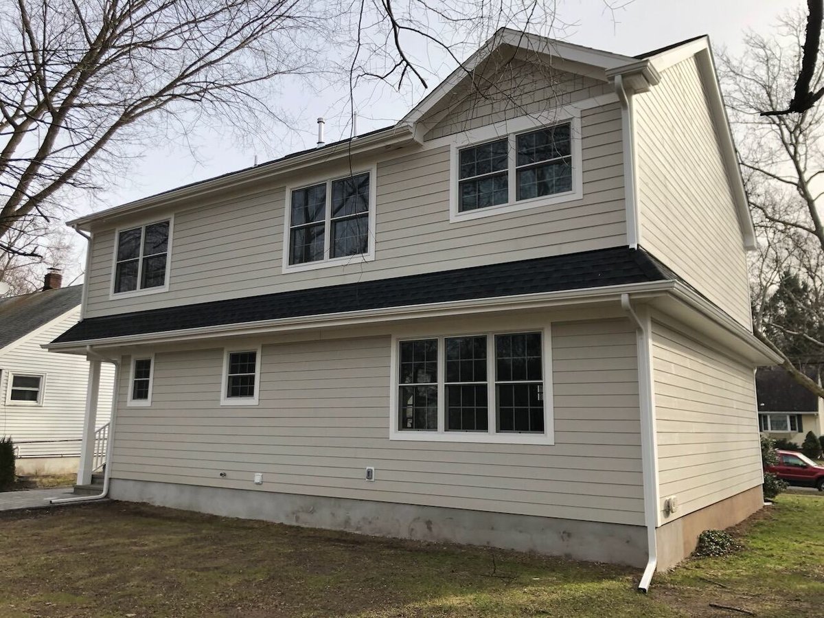 Rear exterior view of two-story custom home in Ridgewood, NJ by Fairmount Heights Homes.