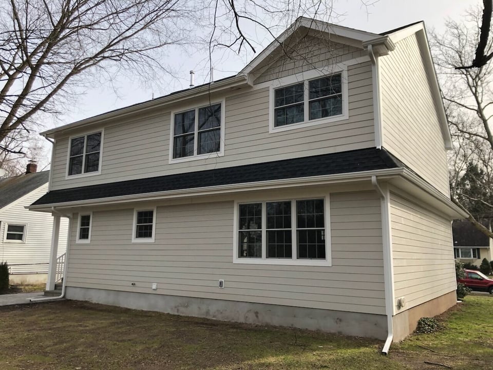 Rear exterior view of two-story custom home in Ridgewood, NJ by Fairmount Heights Homes
