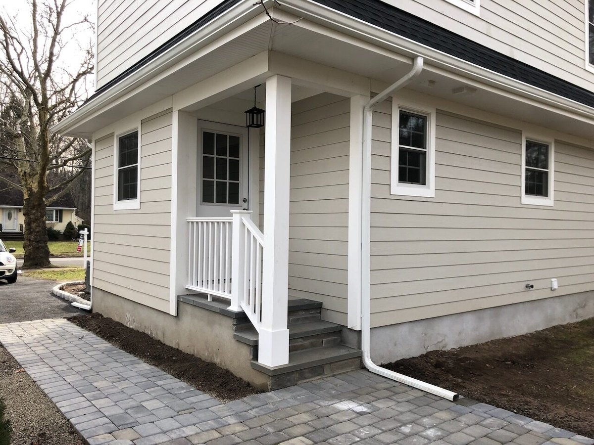 Side entry porch with steps and paver walkway in Ridgewood, NJ home by Fairmount Heights Homes.