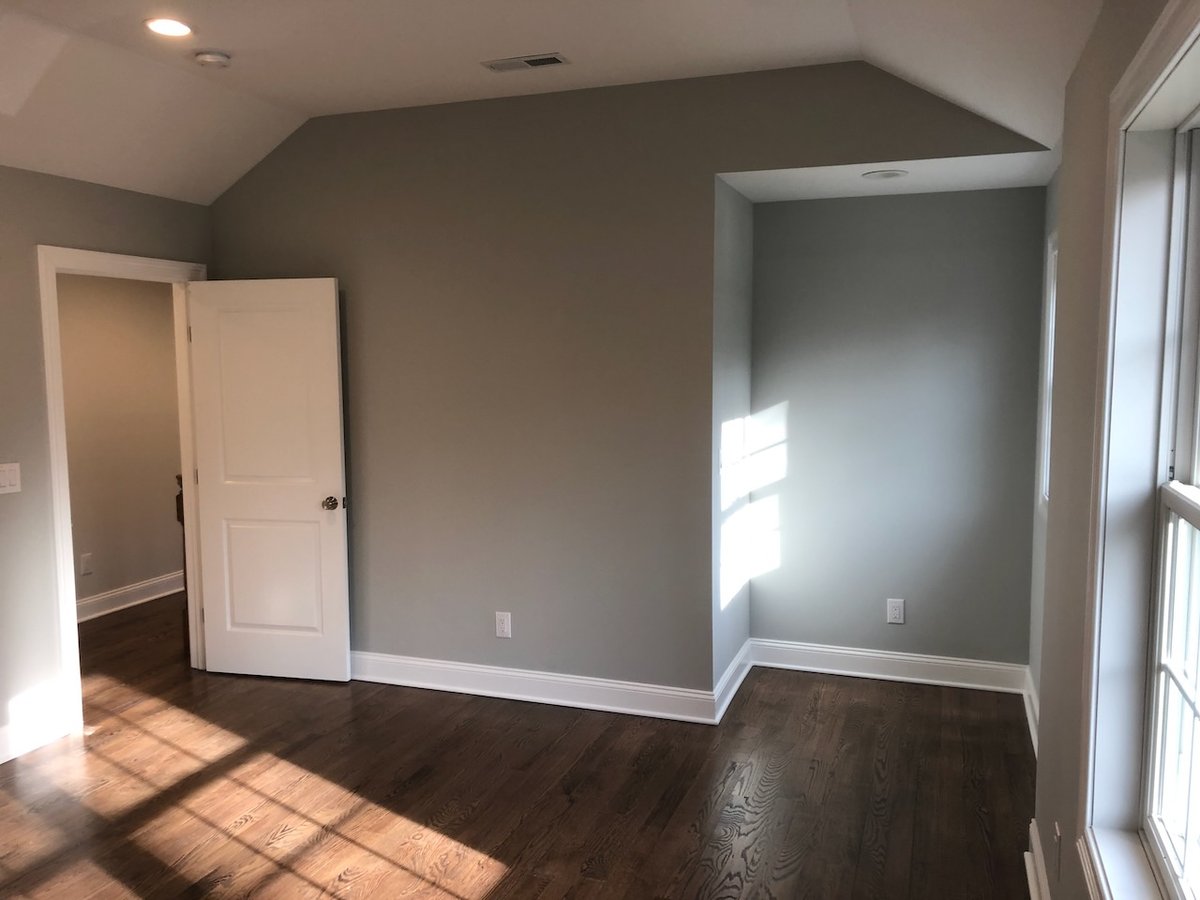 Spacious primary bedroom with recessed lights and neutral design in Ridgewood custom home.
