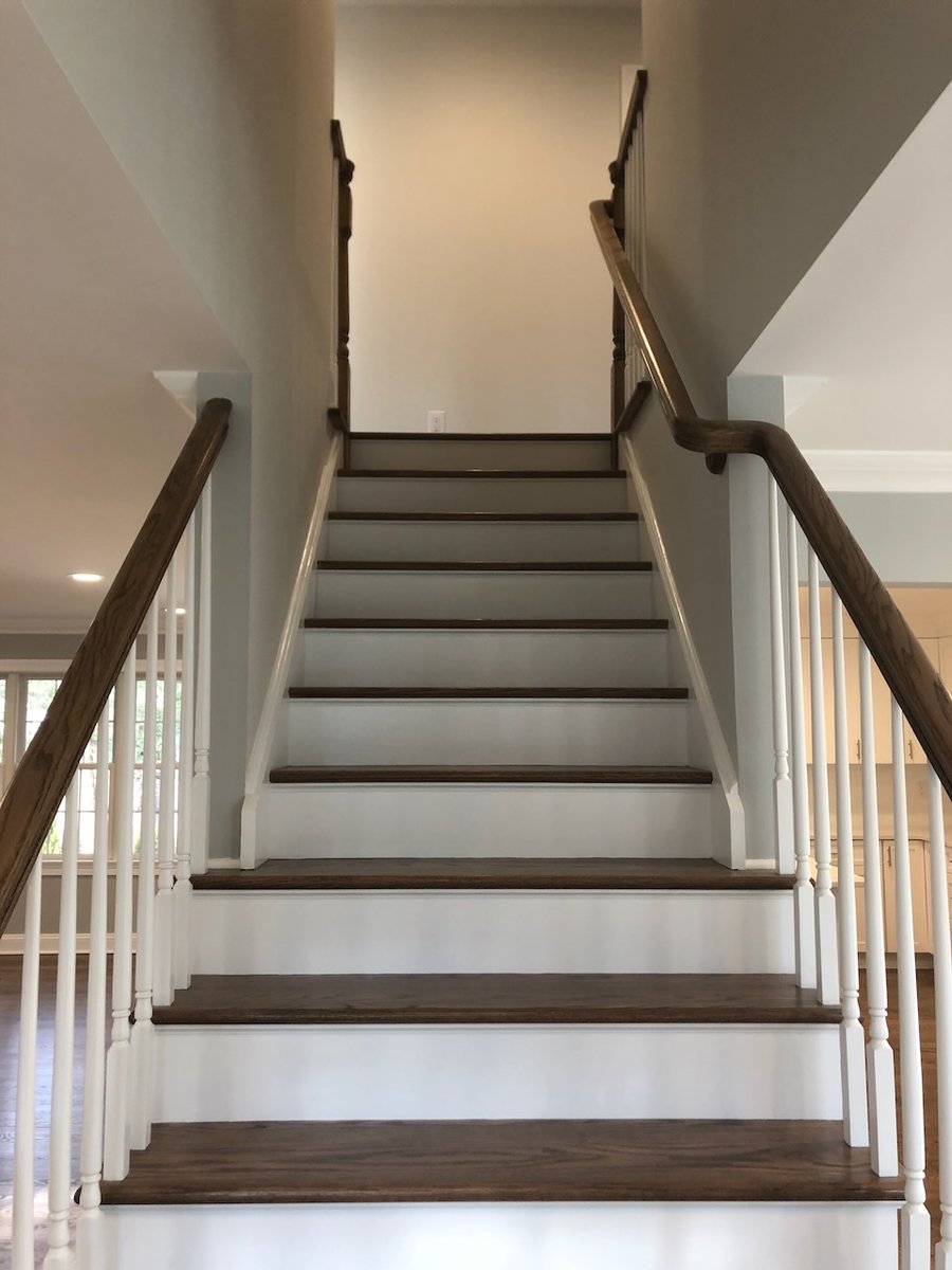 Staircase with wood treads and white risers leading to second floor in Ridgewood, NJ custom home.