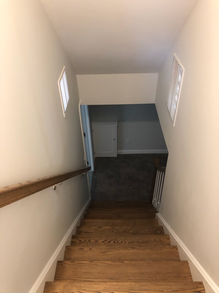 Stairs transitioning from hardwood to carpet in Ridgewood, NJ custom home by Fairmount Heights Homes.