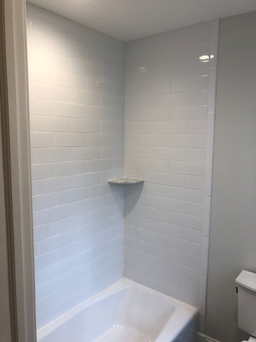 Tiled bathtub alcove in a custom bathroom project in Ridgewood by Fairmount Heights Homes.