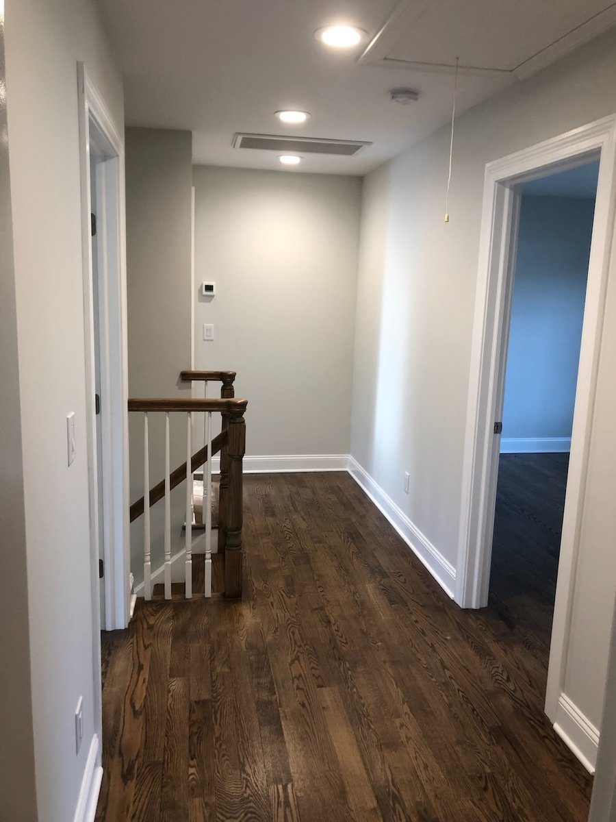 View toward stair landing from upper hallway in Ridgewood custom home by Fairmount Heights Homes.