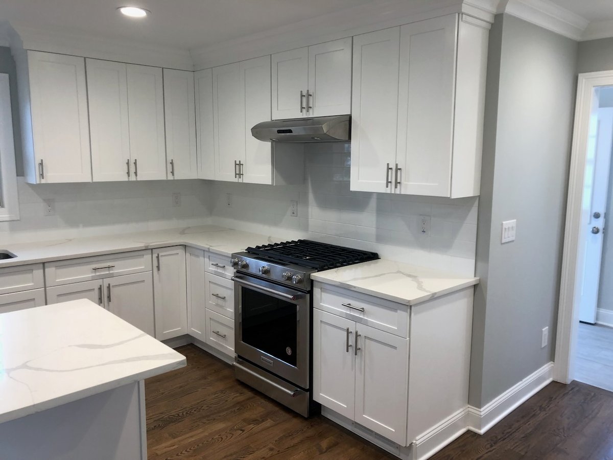 White custom kitchen with corner range and quartz countertops in Ridgewood, NJ.