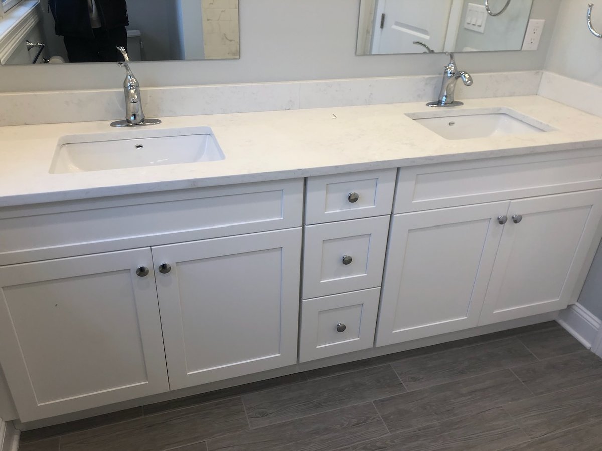 White shaker-style cabinetry in bathroom remodel by Fairmount Heights Homes in Ridgewood, NJ.