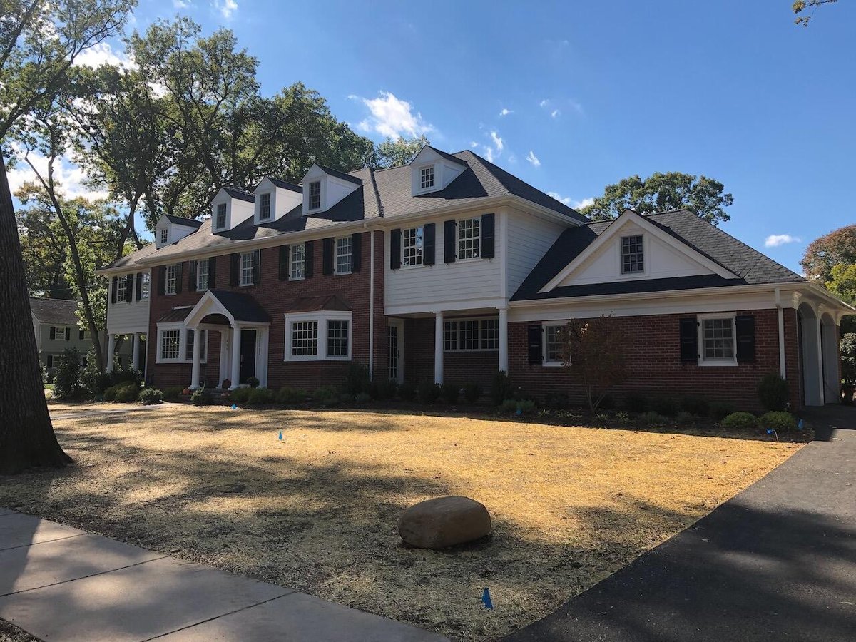 Expansive two-story home with multiple dormers and detailed landscaping in Ridgewood, NJ by Fairmount Heights Homes.