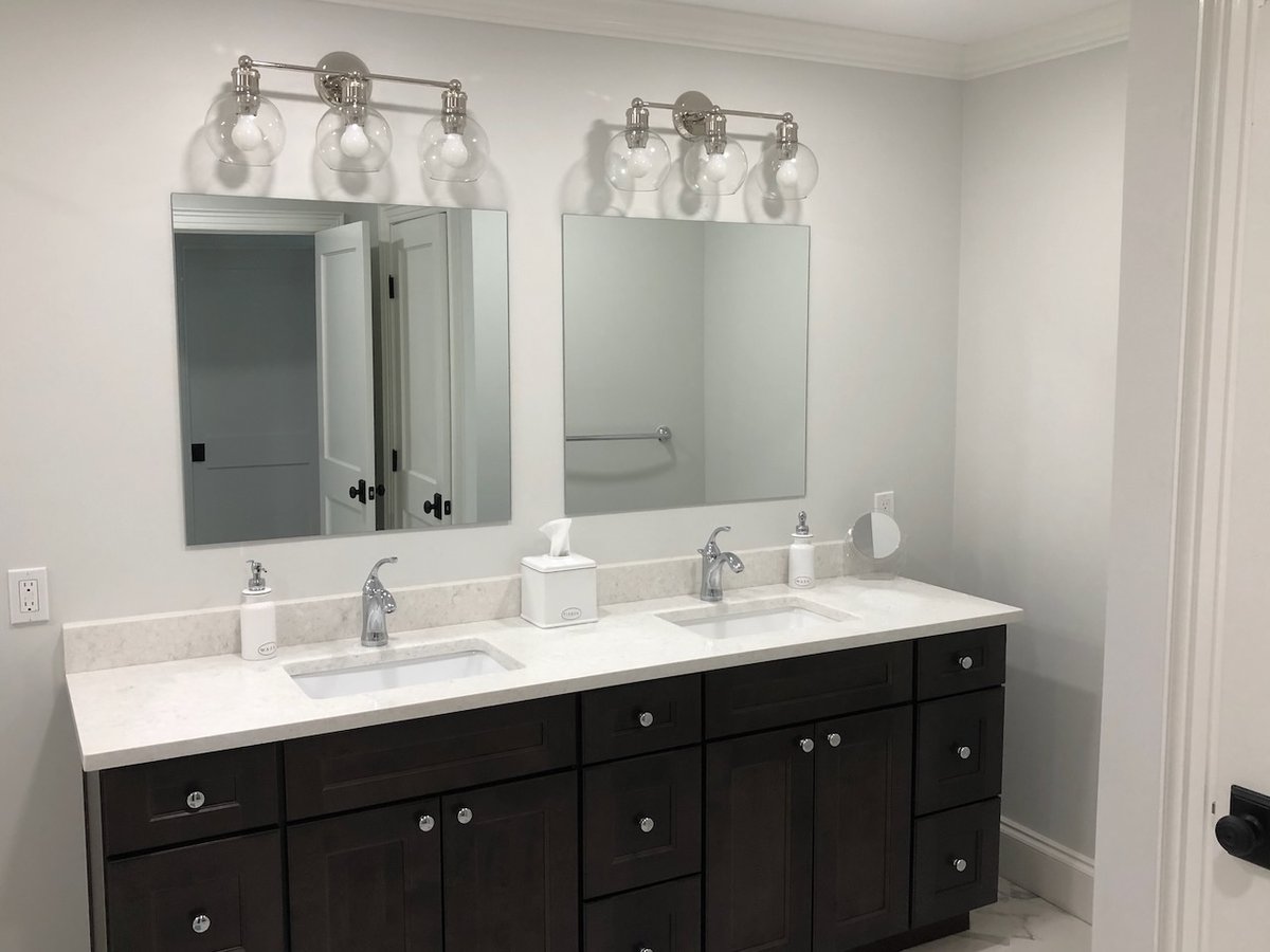 Master bathroom featuring dark wood cabinetry and polished chrome fixtures in Ridgewood, NJ custom home by Fairmount Heights Homes.
