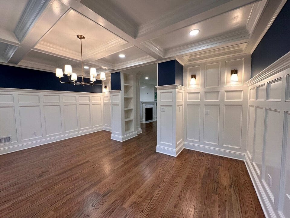 Full dining room view with wainscoting and chandelier by Fairmount Heights Homes in Ridgewood, NJ