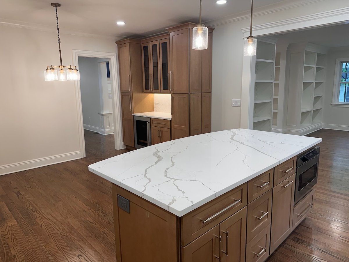 Large kitchen island with microwave drawer and ample storage by Fairmount Heights Homes in Ridgewood, NJ.