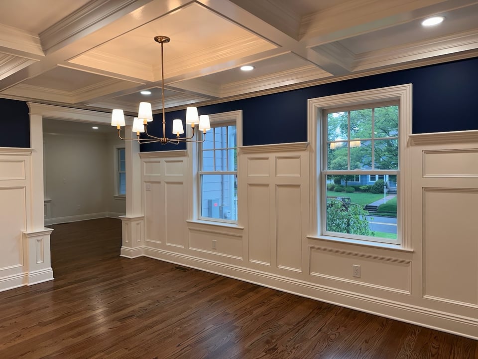 Dining room with coffered ceiling and blue accent walls by Fairmount Heights Homes in Ridgewood, NJ
