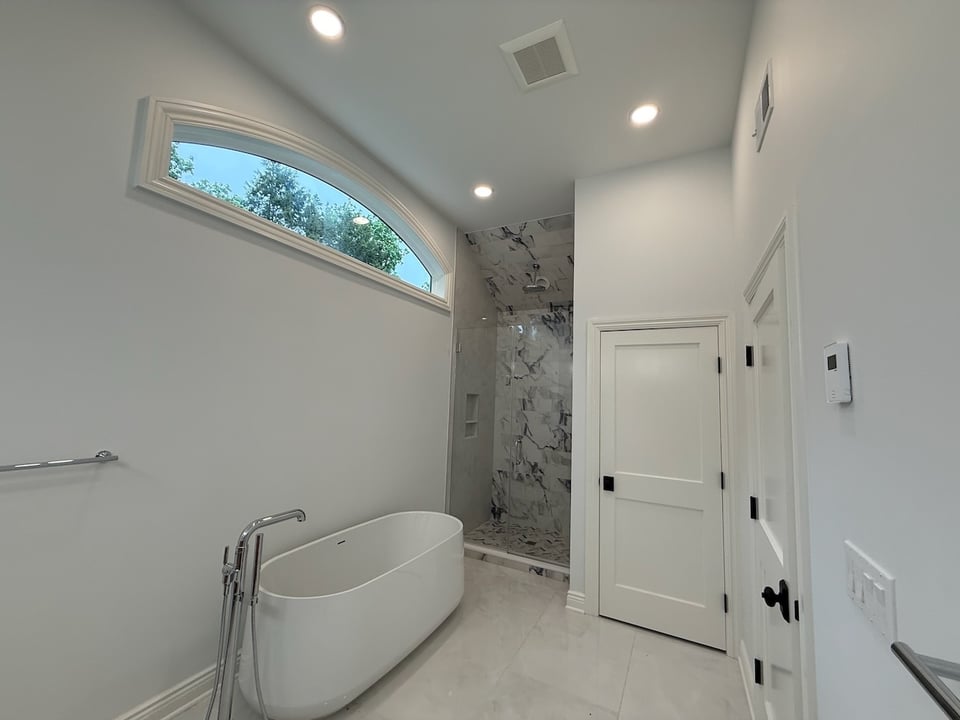 Spa-like bathroom with freestanding tub and marble walk-in shower in Ridgewood, NJ custom home by Fairmount Heights Homes