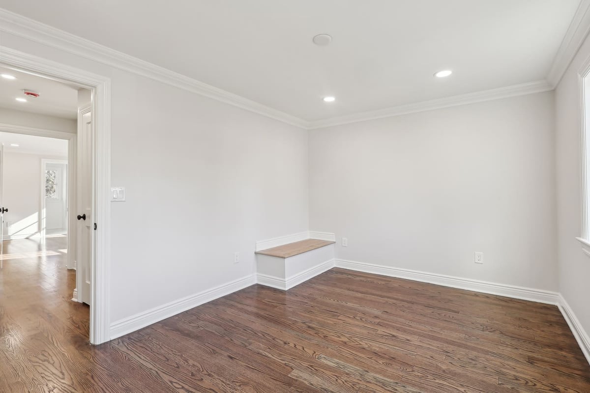 Bedroom in Ridgewood, NJ with hardwood floors and built-in bench