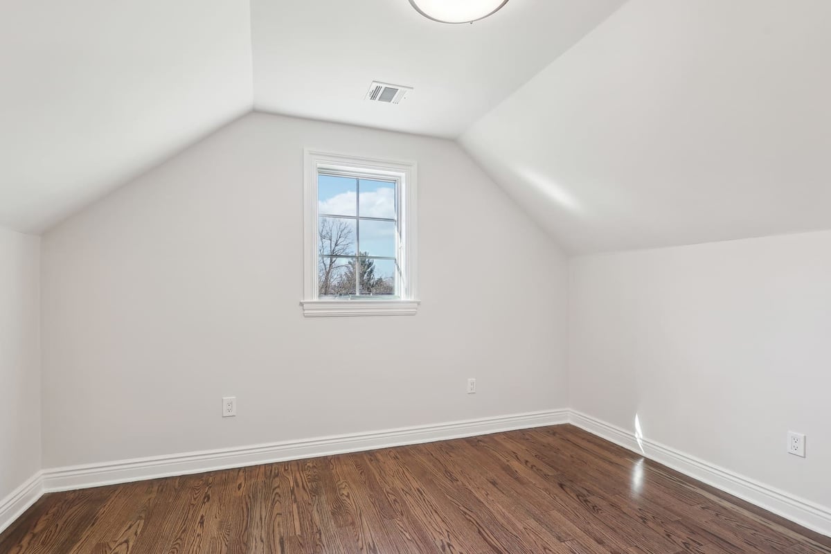 Bedroom in Ridgewood, NJ with vaulted ceiling and hardwood floors