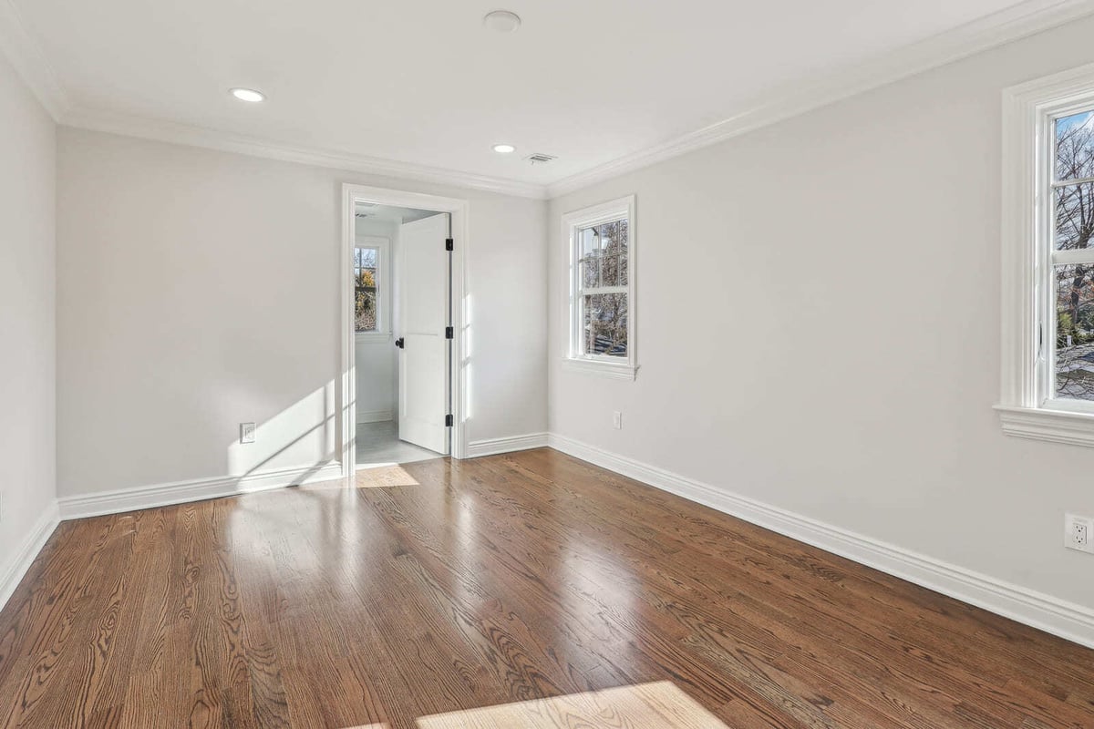 Bright bedroom in Ridgewood, NJ with hardwood floors and multiple windows