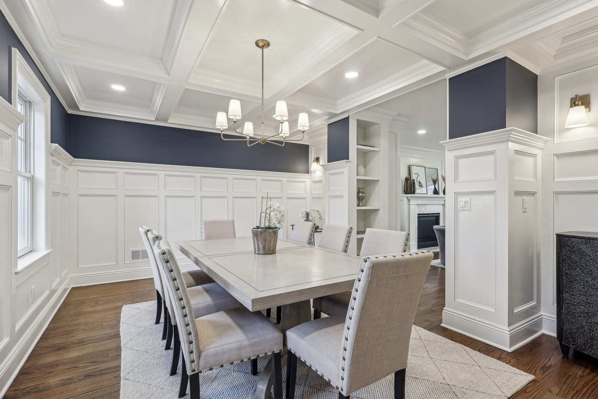 Bright dining area in Ridgewood, NJ with detailed millwork, coffered ceiling, and neutral decor