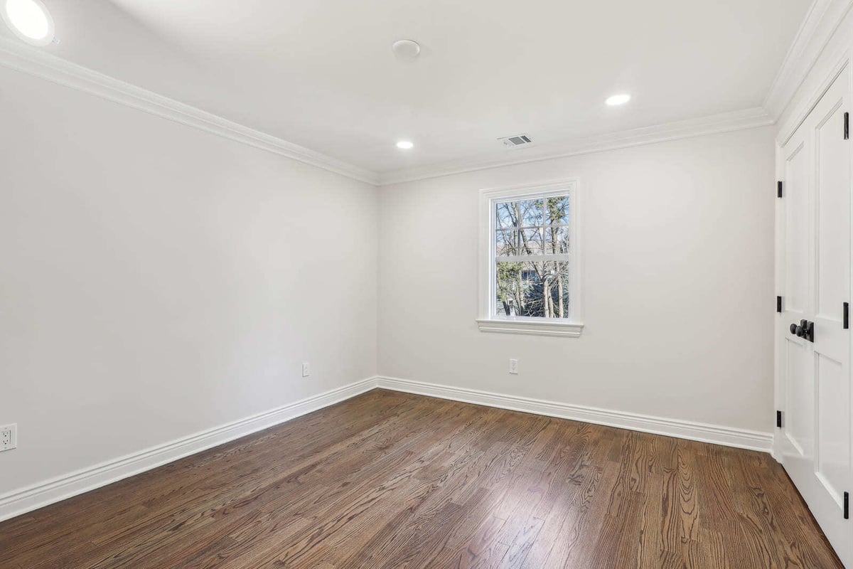 Empty bedroom in Ridgewood, NJ with hardwood floors and single window