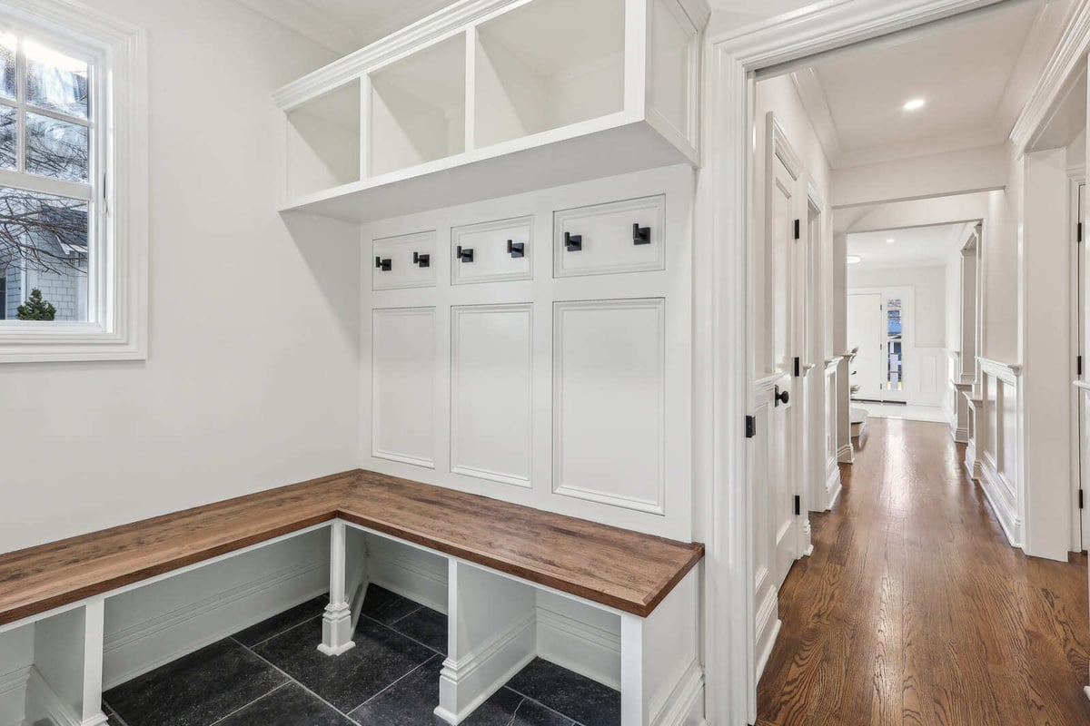 Mudroom in Ridgewood, NJ with built-in bench, hooks, and storage cubbies