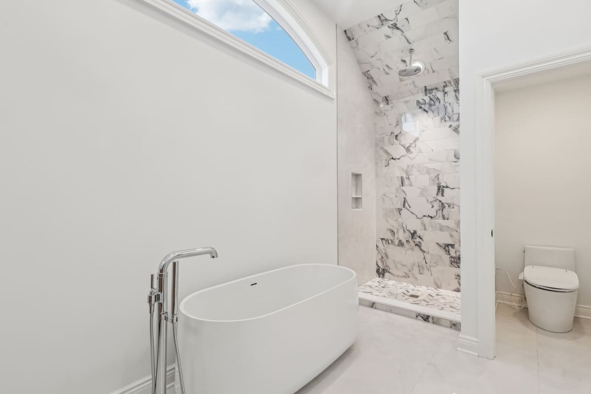 Primary bathroom in Ridgewood, NJ with freestanding tub and marble walk-in shower