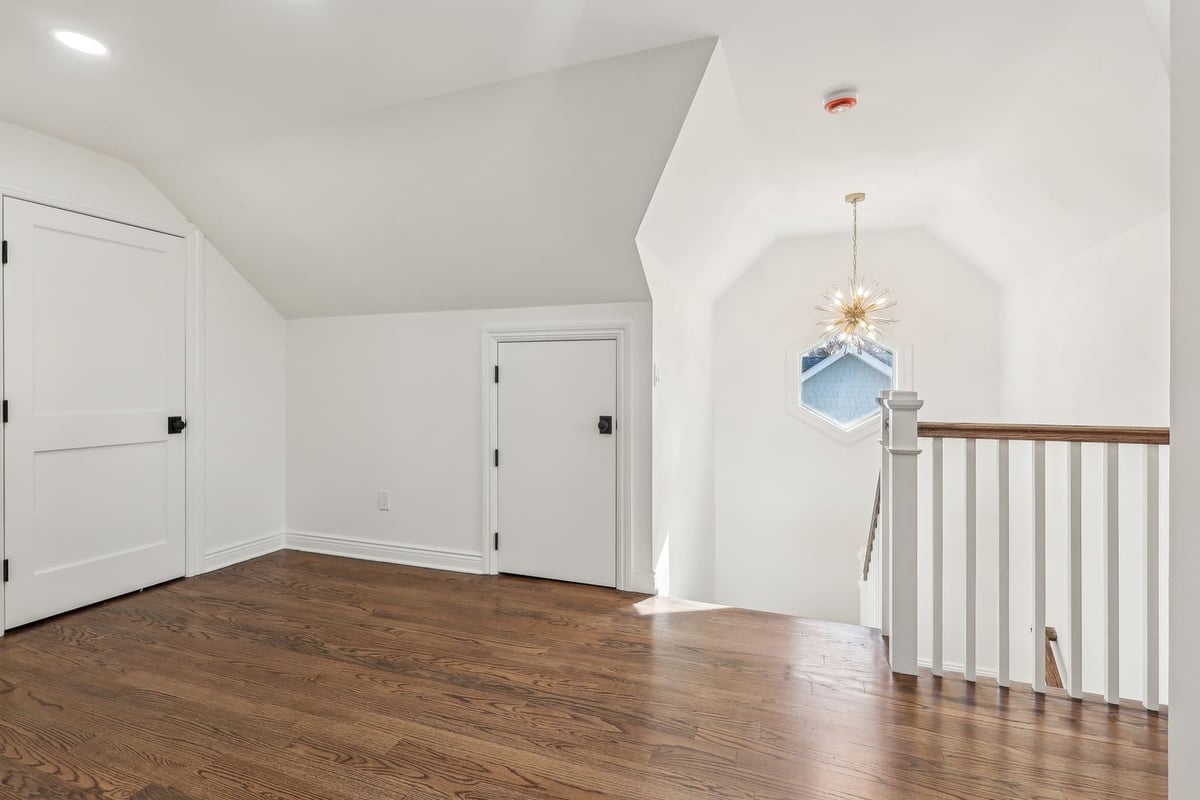 Upper hallway in Ridgewood, NJ with hardwood floors and stair railing