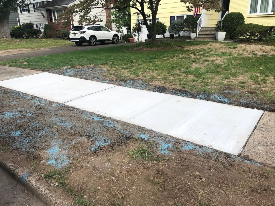 Replaced concrete sidewalk in front of Ridgewood home with clean panel joints.