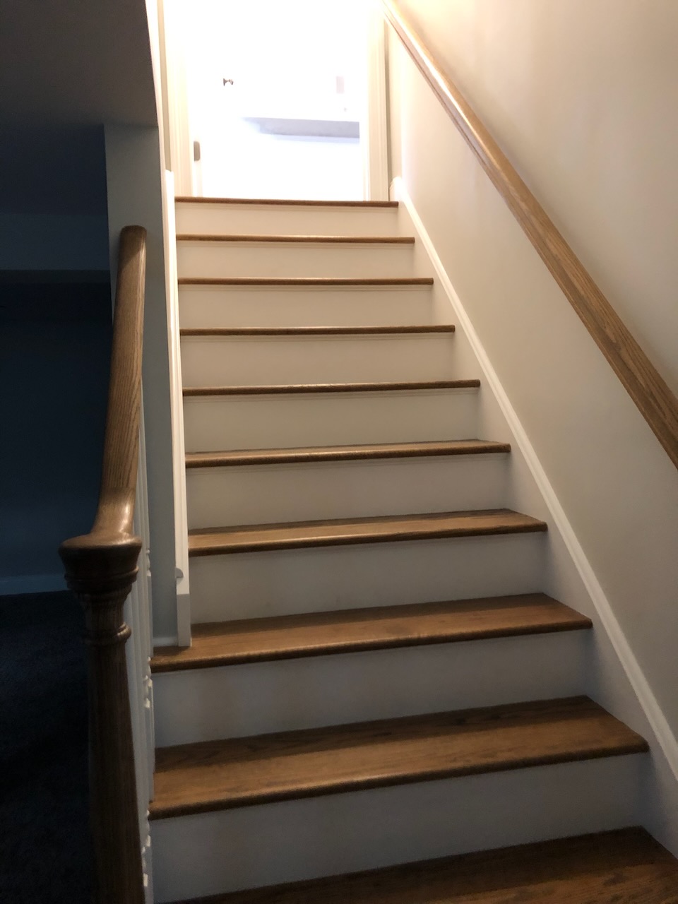 Finished staircase leading from basement to main floor in Ridgewood custom home by Fairmount Heights Homes.