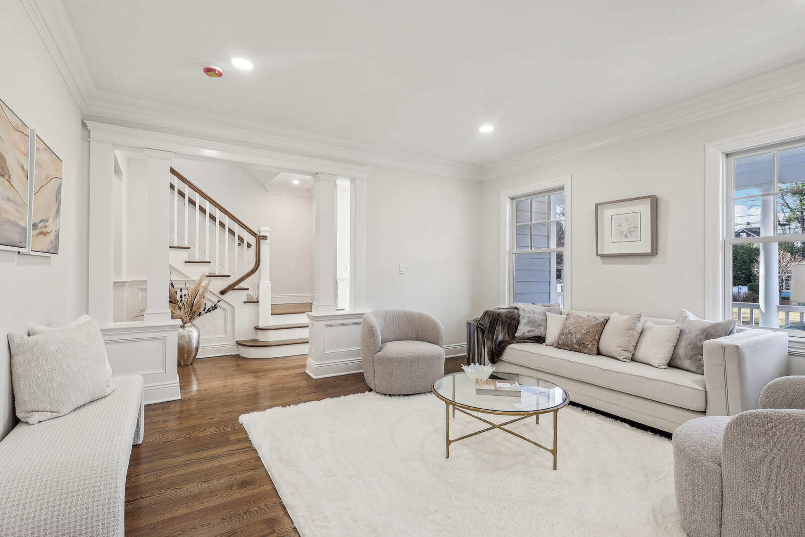 Elegant living room in Ridgewood, NJ with hardwood floors, staircase, and soft neutral decor