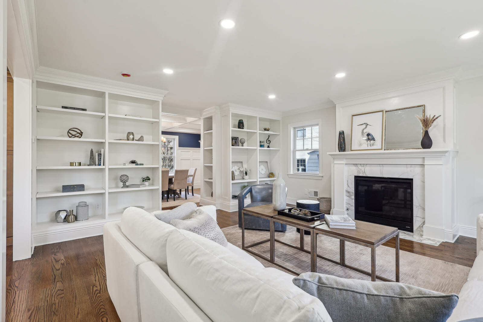 Living room in Ridgewood, NJ with built-in shelves, marble fireplace, and hardwood floors