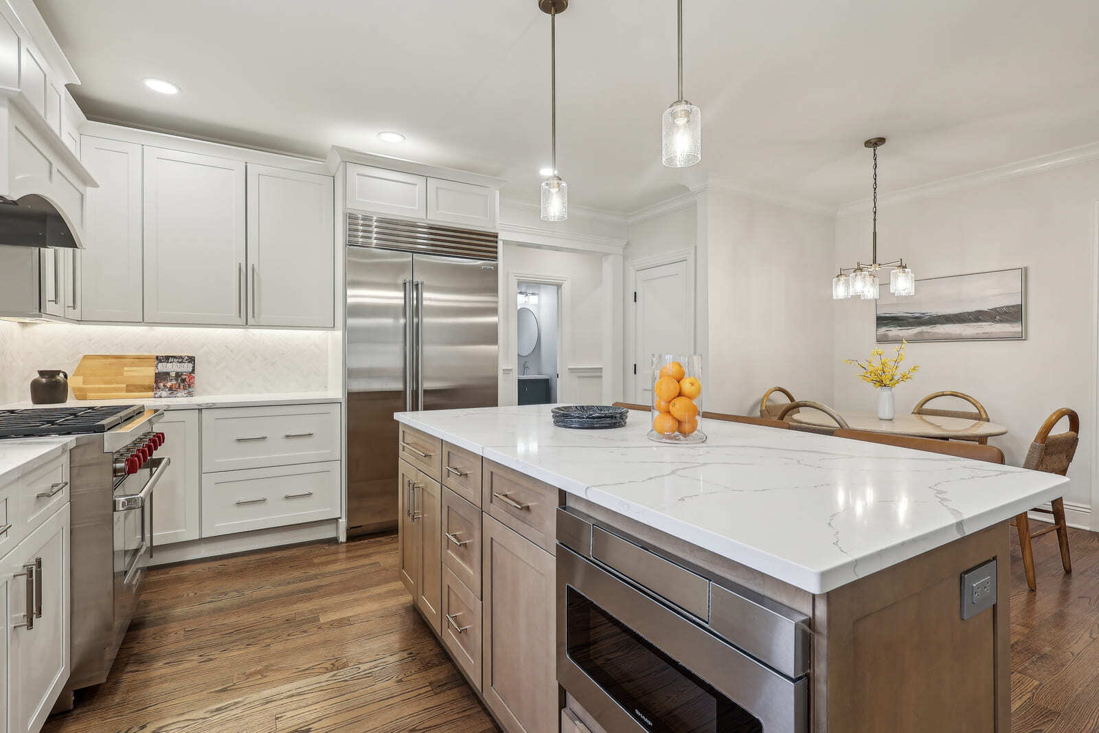 Spacious kitchen in Ridgewood, NJ with stainless appliances, island seating, and open dining area